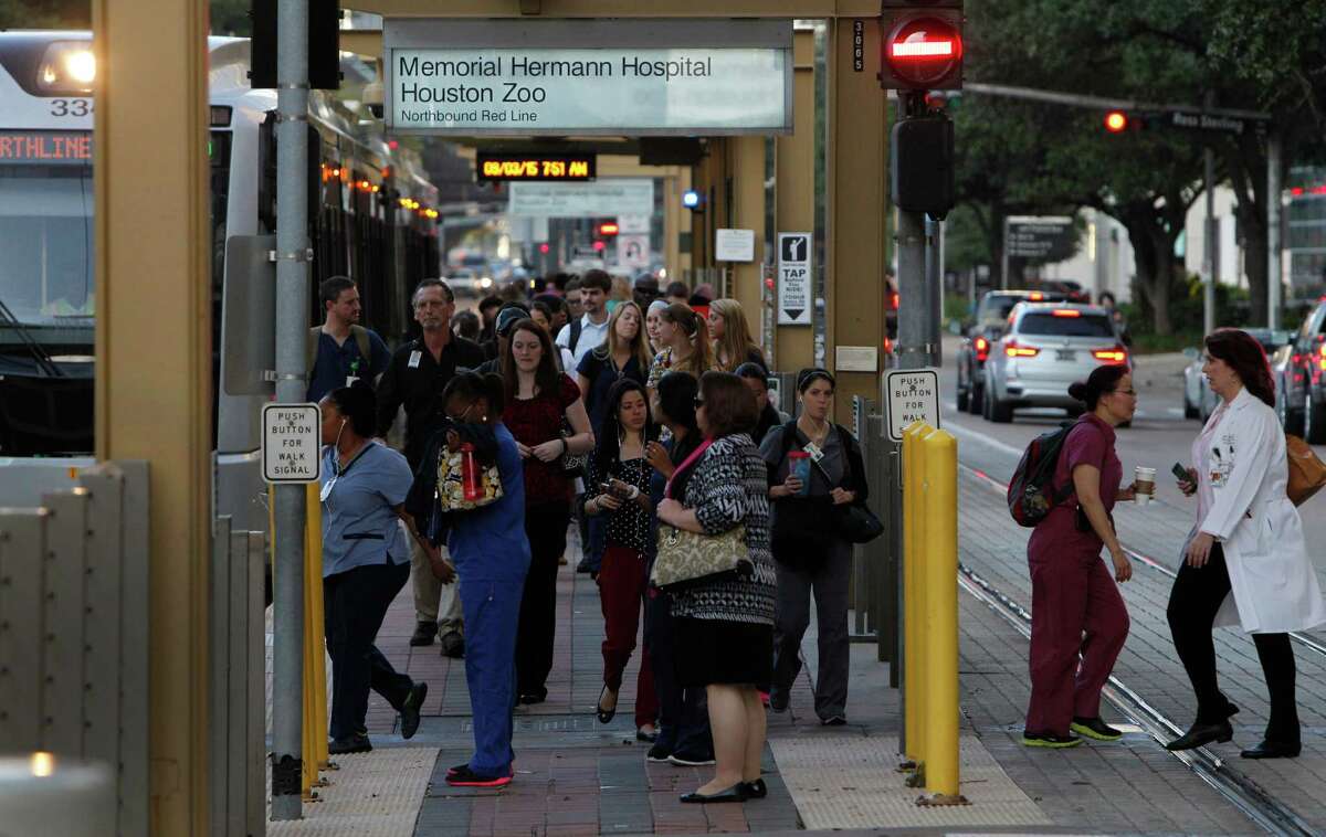 ﻿Commuters bustle Sept. 5 at a light rail stop in the Texas Medical Center. Metro is revising plasn to extend rail from the medical center southwest to Missouri City.