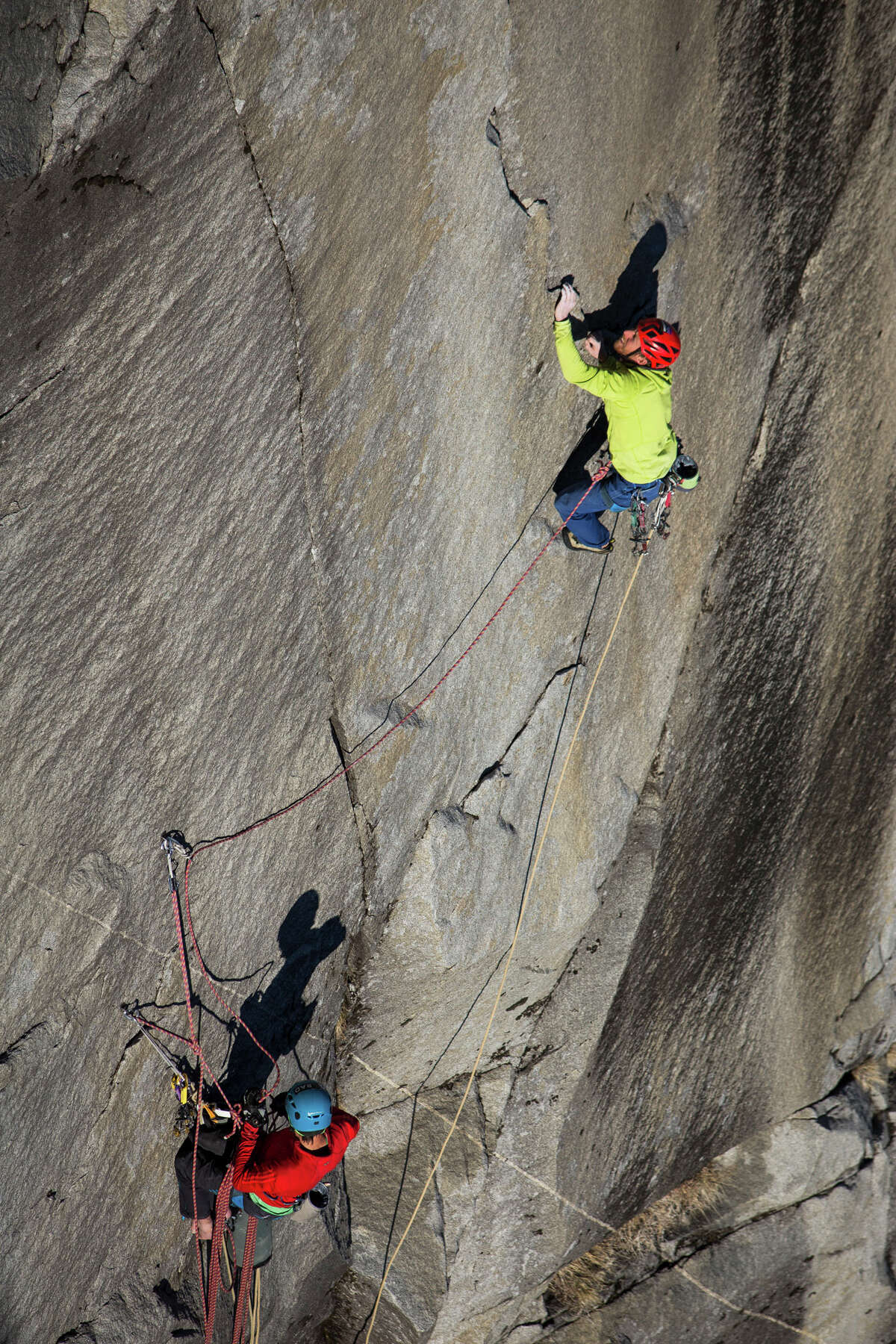 Tommy Caldwell (top) ascends the final pitch of the Dawn Wall on El Capitan, belayed by his climbing partner, Kevin Jorgeson, in Yosemite National Park in January. Using ropes as a safety measure only, Caldwell and Jorgeson became the first to climb by hand the 3,000-foot granite wall, an ascent they began Dec. 27.