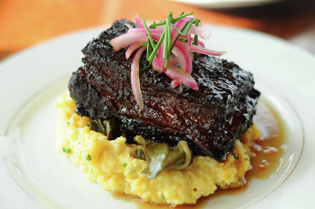 The beef belly burnt ends with cheese grits, braised greens and cane syrup at Southern Goods at 632 W. 19th St. Wednesday Sept. 2,2015.(Dave Rossman photo)