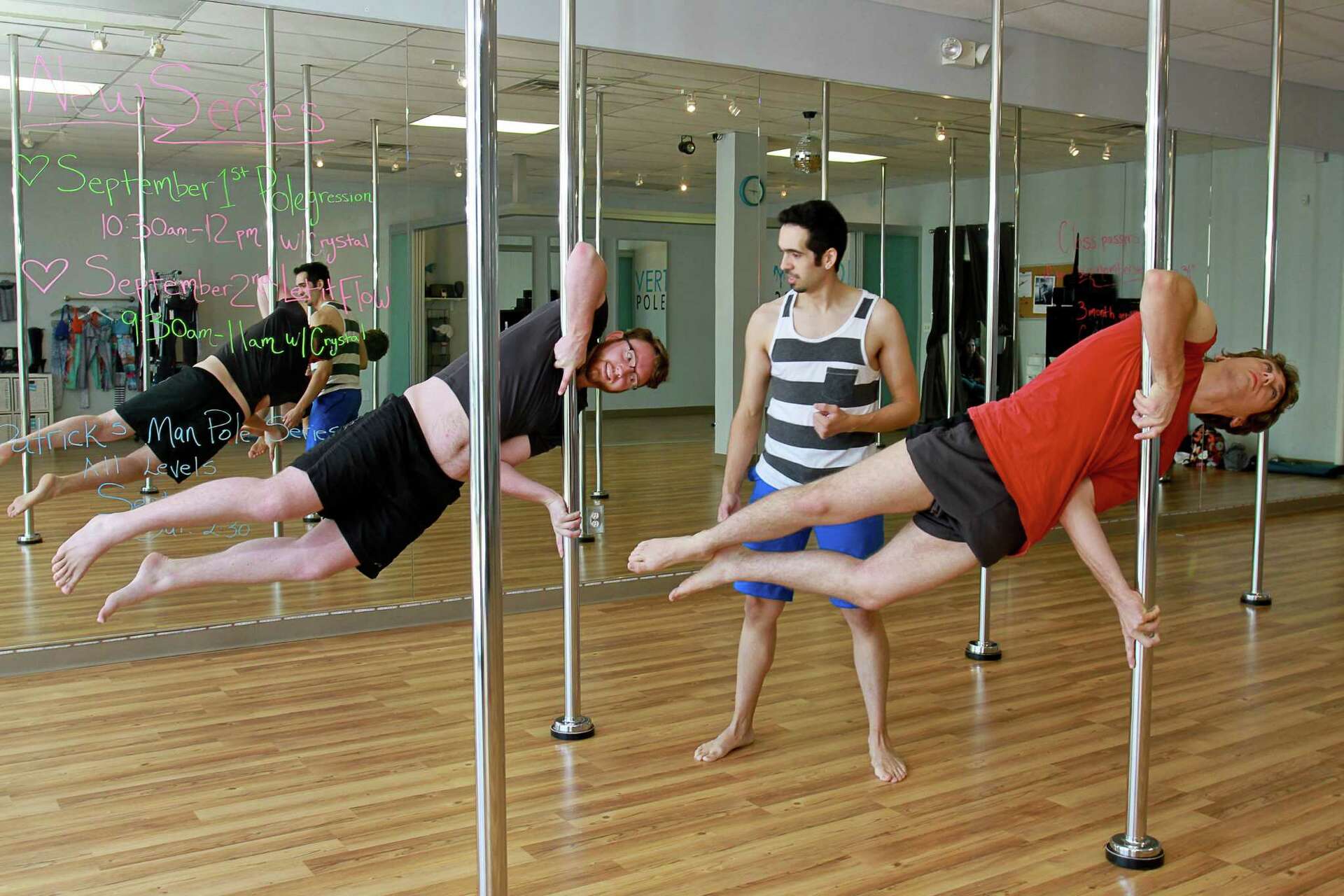 Men seeking workout challenge take pole-dancing class for a spin