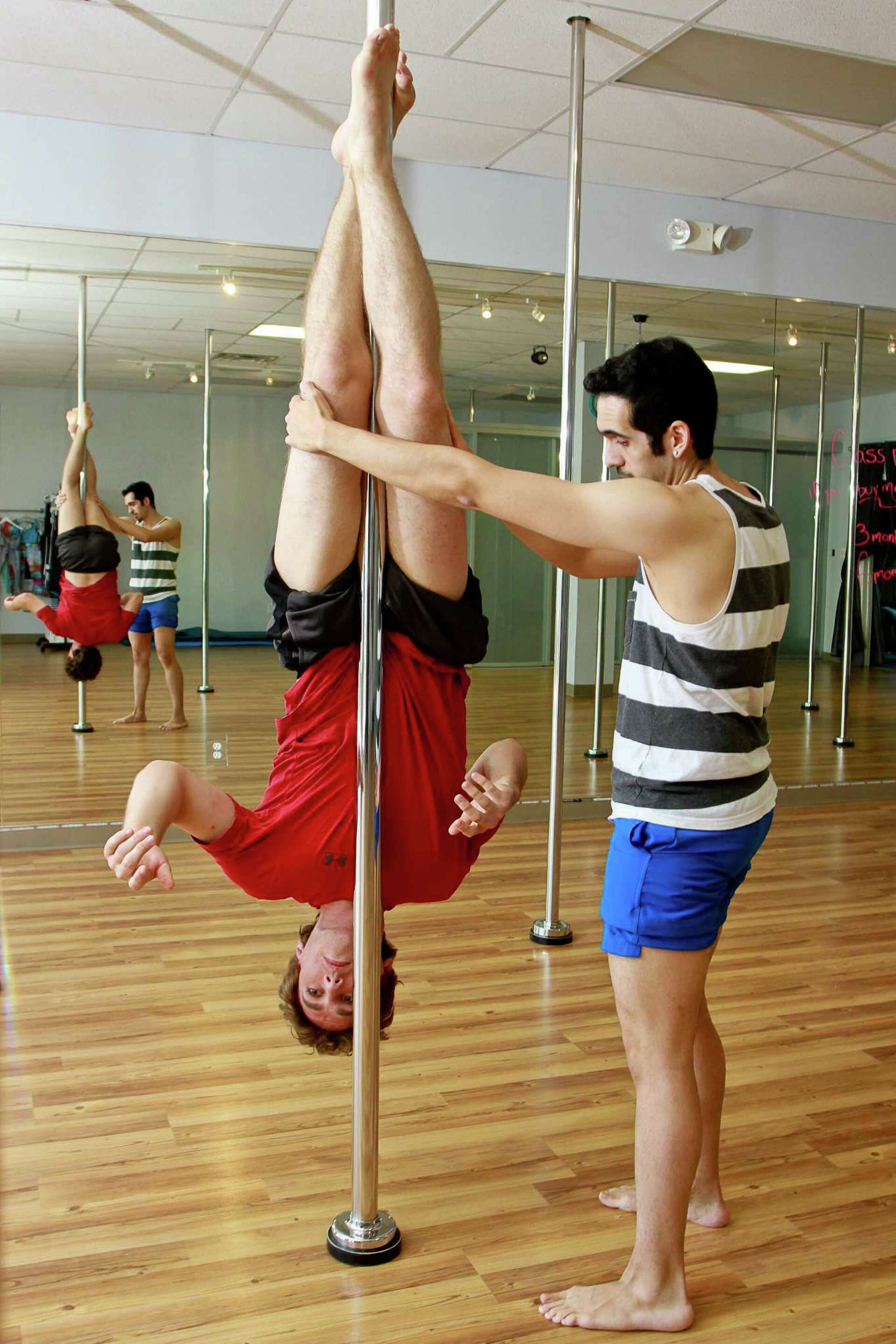 Men seeking workout challenge take pole-dancing class for a spin