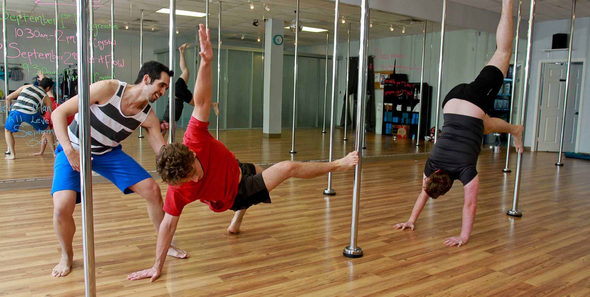 Men seeking workout challenge take pole-dancing class for a spin