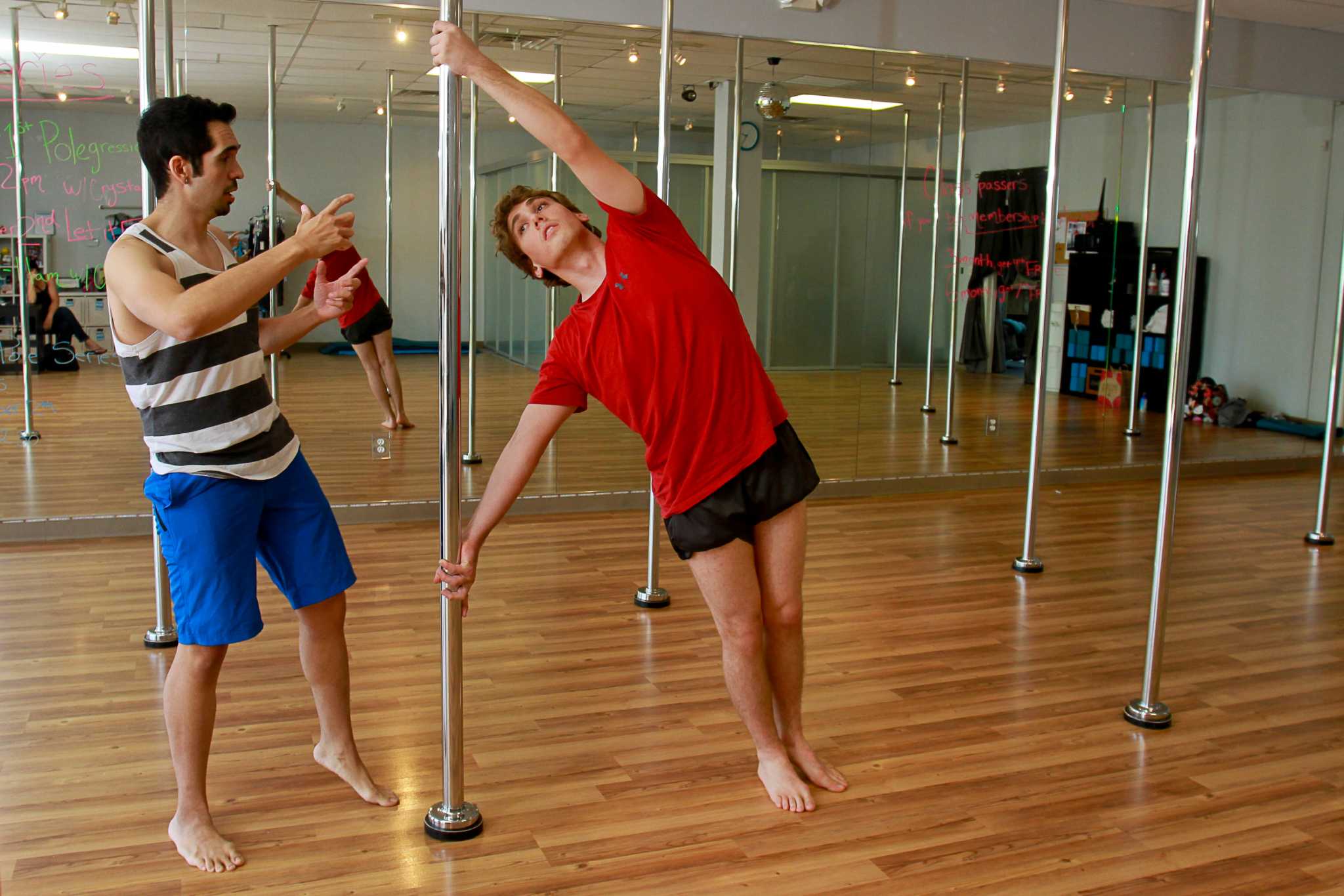 Men seeking workout challenge take pole-dancing class for a spin