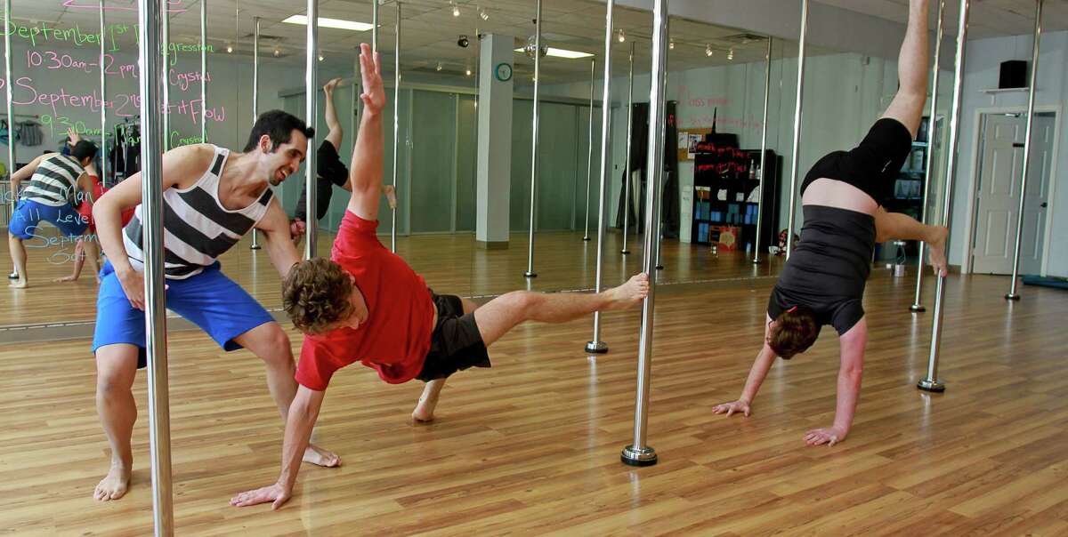 Men seeking workout challenge take poledancing class for a spin