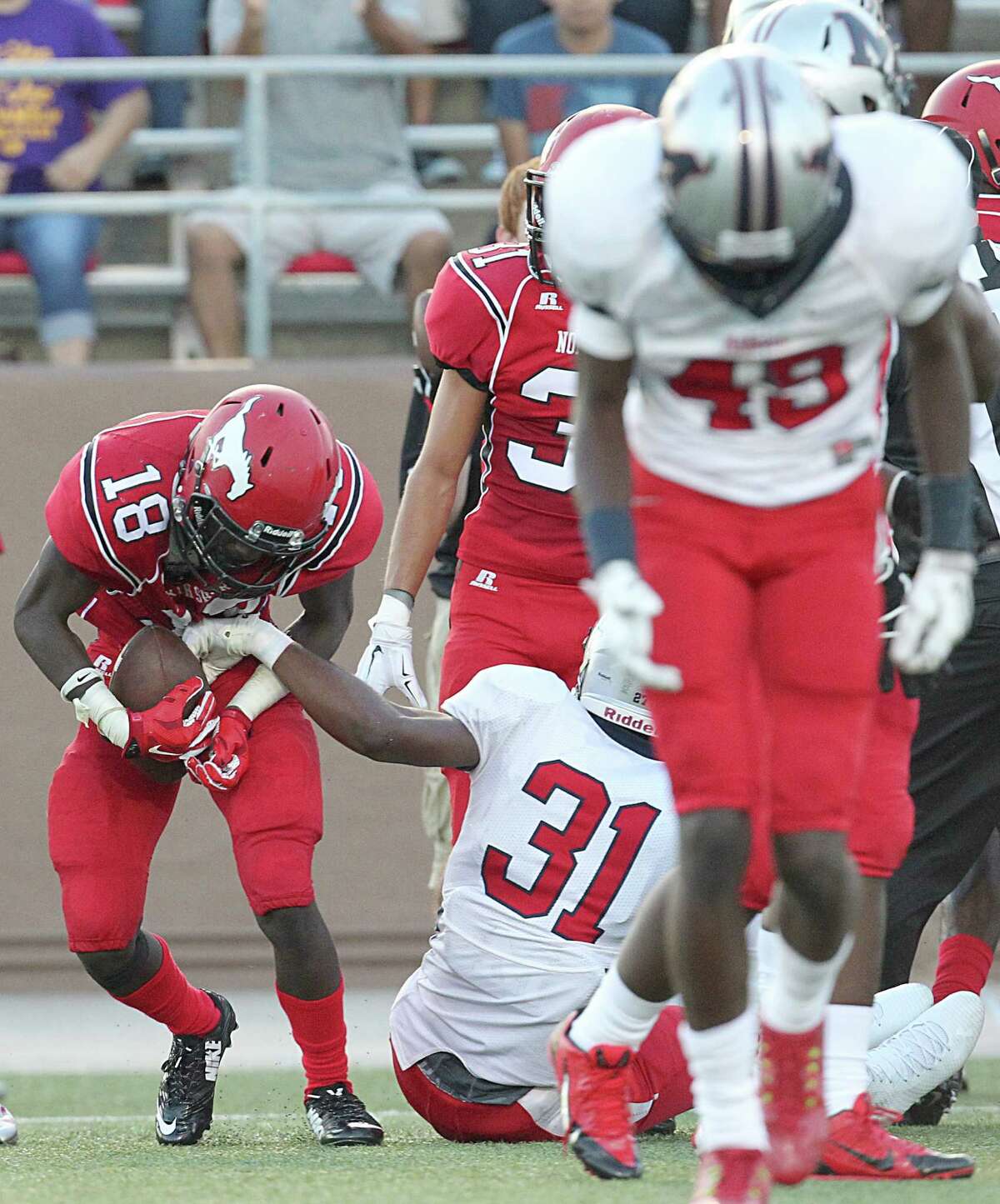 North Shore defensive back Jalen Thomas (18) recovers a Manvel fumble in the first half of what would become a back-and-forth game Friday night.