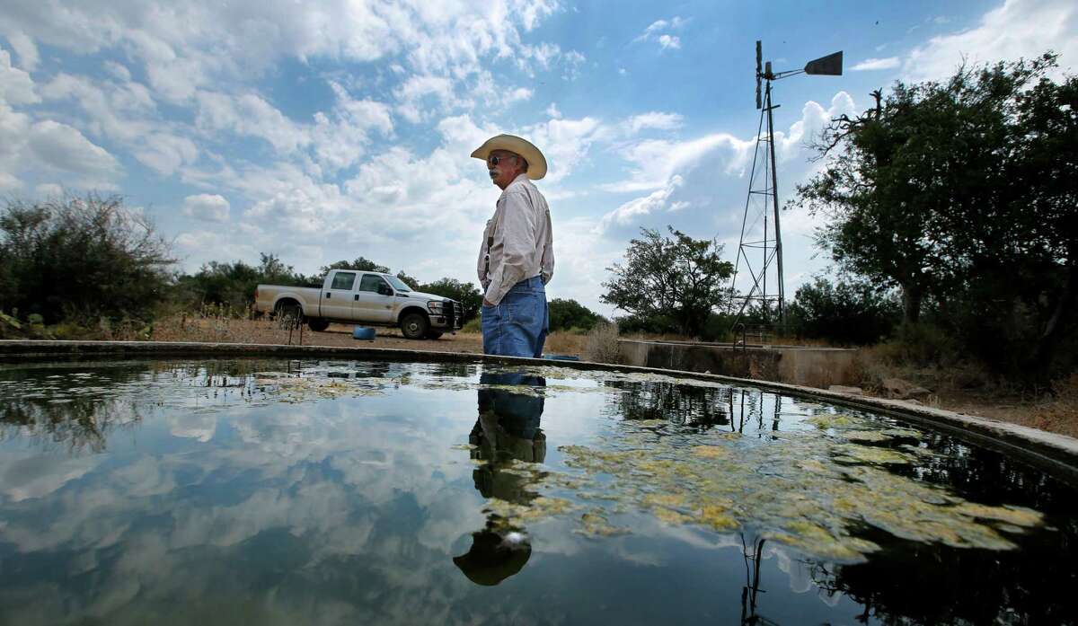 Rancher Ron Crocker, who owns CA Cattle Company outside Mason, checks on his windmill-driven freshwater stock pools. A proposal by an Italian energy developer to build a wind farm in the heart of Hill Country has stirred up the ire of locals.﻿