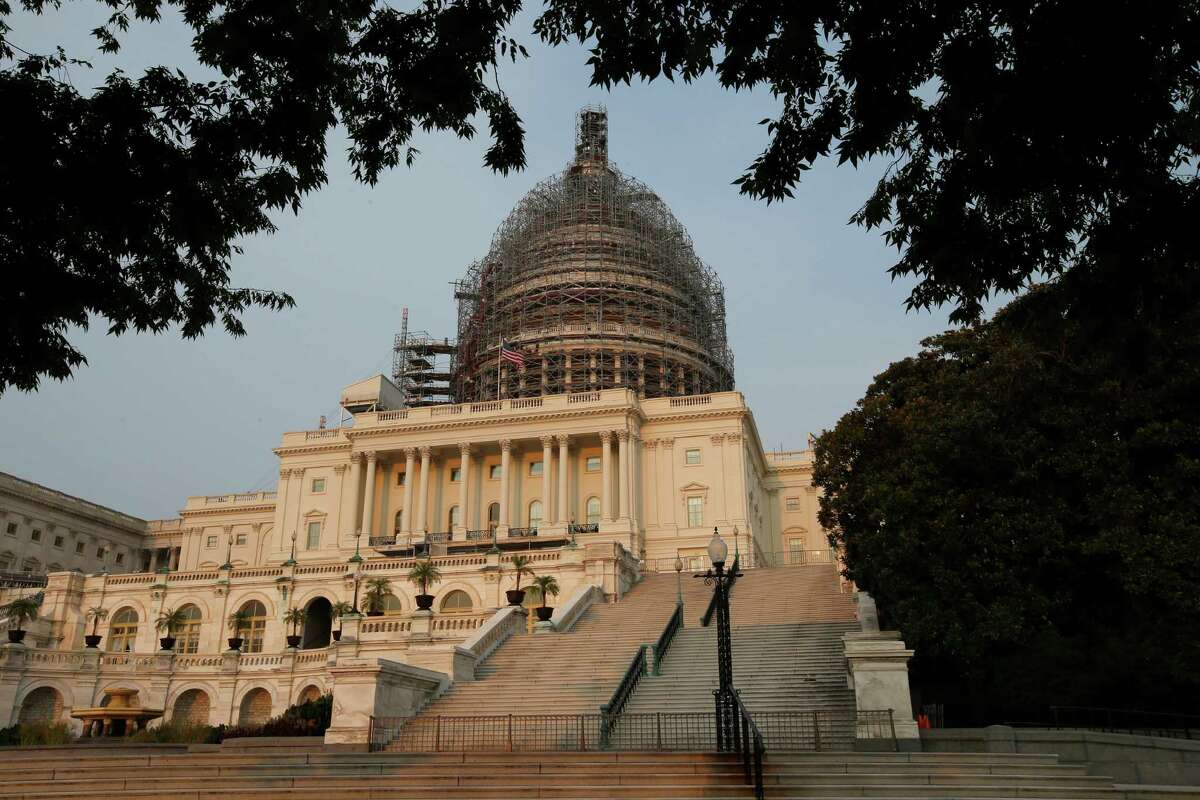 The west front of the U.S. Capitol is seen under repair Sept. 2, 2015 in Washington. Congress returns on Sept. 8 with a critical need for a characteristic that has been rare through a contentious spring and summer _ cooperation between Republicans and President Barack Obama. Lawmakers face a weighty list of unfinished business and looming deadlines, with a stopgap spending bill to keep the government open on Oct. 1 paramount. (AP Photo/Alex Brandon)