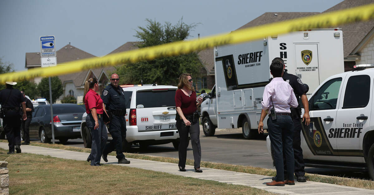 Bexar County sheriff’s officials investigate the scene in the Walnut Pass neighborhood where deputies shot a man as they responded to a domestic disturbance call.