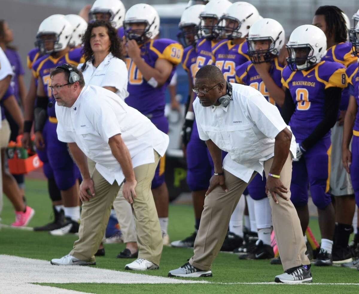 Brackenridge football coach Willie Hall, right, watches his team in action against Devine during high school football action at Alamo Stadium on Sept. 5, 2015.