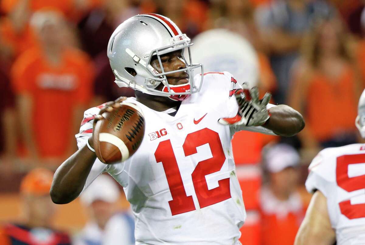 Ohio State quarterback Cardale Jones (12) looks for a receiver during the first half of an NCAA college football game against Virginia Tech in Blacksburg, Va., Monday, Sept. 7, 2015. (AP Photo/Steve Helber)