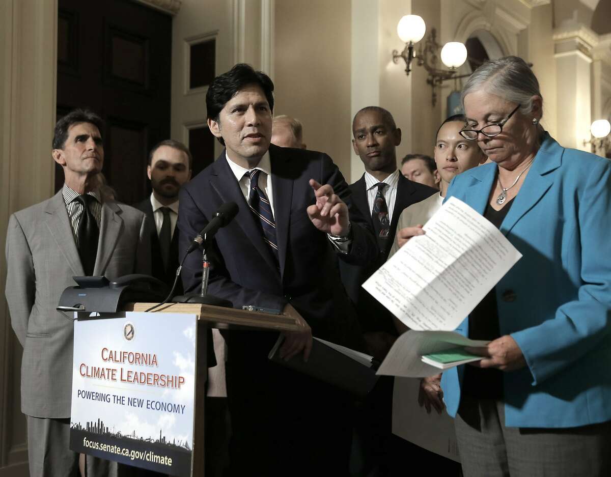 State Senate President Pro Tem Kevin de Leon, D-Los Angeles, center, answers a question concerning a pair of environmental measures before the Legislature, during a news conference,Tuesday, Aug. 25, 2015, in Sacramento, Calif. De Leon's SB350 calls for boosting renewable energy use to 50 percent by 2030 and SB32, by Sen. Fran Pavley, D-Agoura Hills, right, calls for cutting greenhouse gas emissions by 80 percent from 1990 levels, by 2050. At left is Sen. Mark Leno, D-San Francisco. (AP Photo/Rich Pedroncelli)