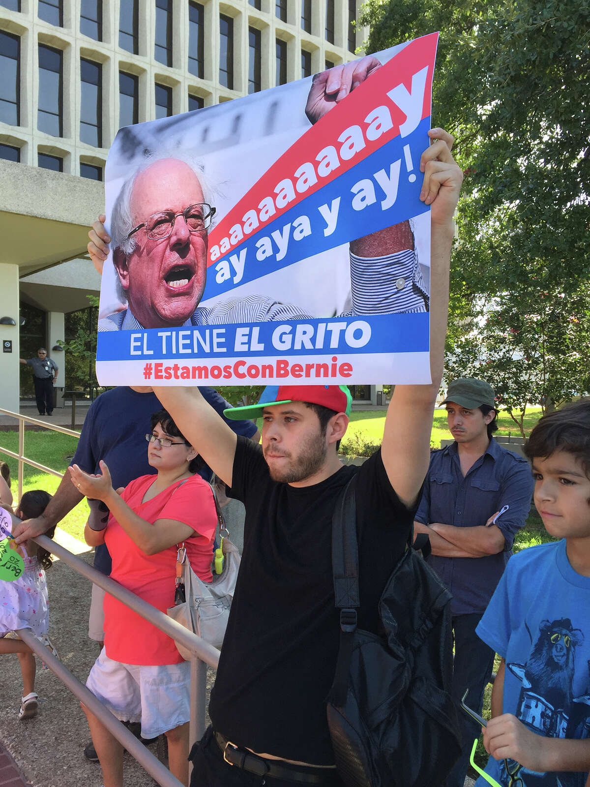Edgar Patino holds a sign at Monday's "Latinos for Bernie" rally.