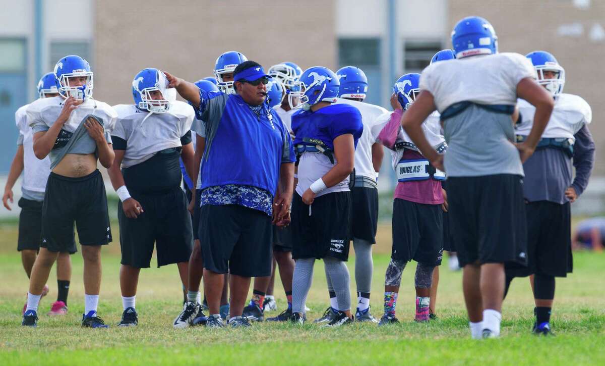 John Jay High School football coach Gary Gutierrez directs players Tuesday afternoon, Sept. 8, 2015 during the first practice since two of their varsity players, Victor Rojas and Mike Moreno, were suspended indefinitely, pending investigation, over violently hitting a referee at the end of last Friday's road game in Marble Falls.
