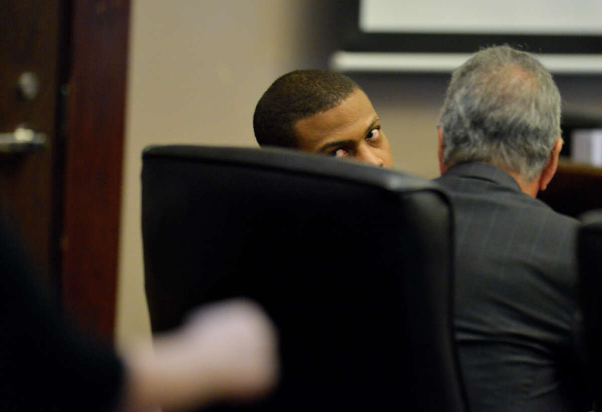 Devin Fields, who is accused of capital murder, looks over his chair at an eye witness walked to the stand to testify during the beginning of his trial Tuesday morning in the 144th District Courtroom.