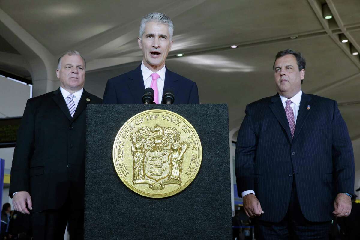 New Jersey Senate President Steve Sweeney, left, and Gov. Chris Christie listen to United Airlines CEO Jeff Smisek at Newark Liberty International Airport in 2013.