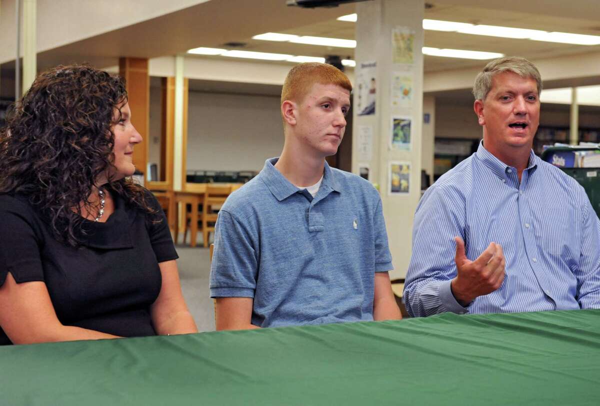 Shenendehowa High School basketball player Kevin Huerter sits in between his parents Erin and Tom as he announces his intentions to play his college basketball at the University of Maryland during a press conference on Tuesday Sept. 8, 2015 in Clifton Park, N.Y. (Lori Van Buren / Times Union)