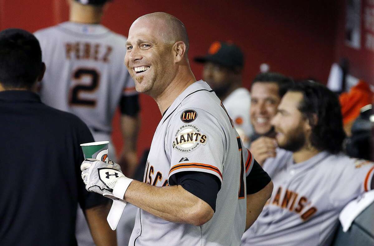 San Francisco Giants' Tim Hudson smiles in the dugout after hitting a home run against the Arizona Diamondbacks during the third inning of a baseball game Tuesday, Sept. 8, 2015, in Phoenix. (AP Photo/Ross D. Franklin)