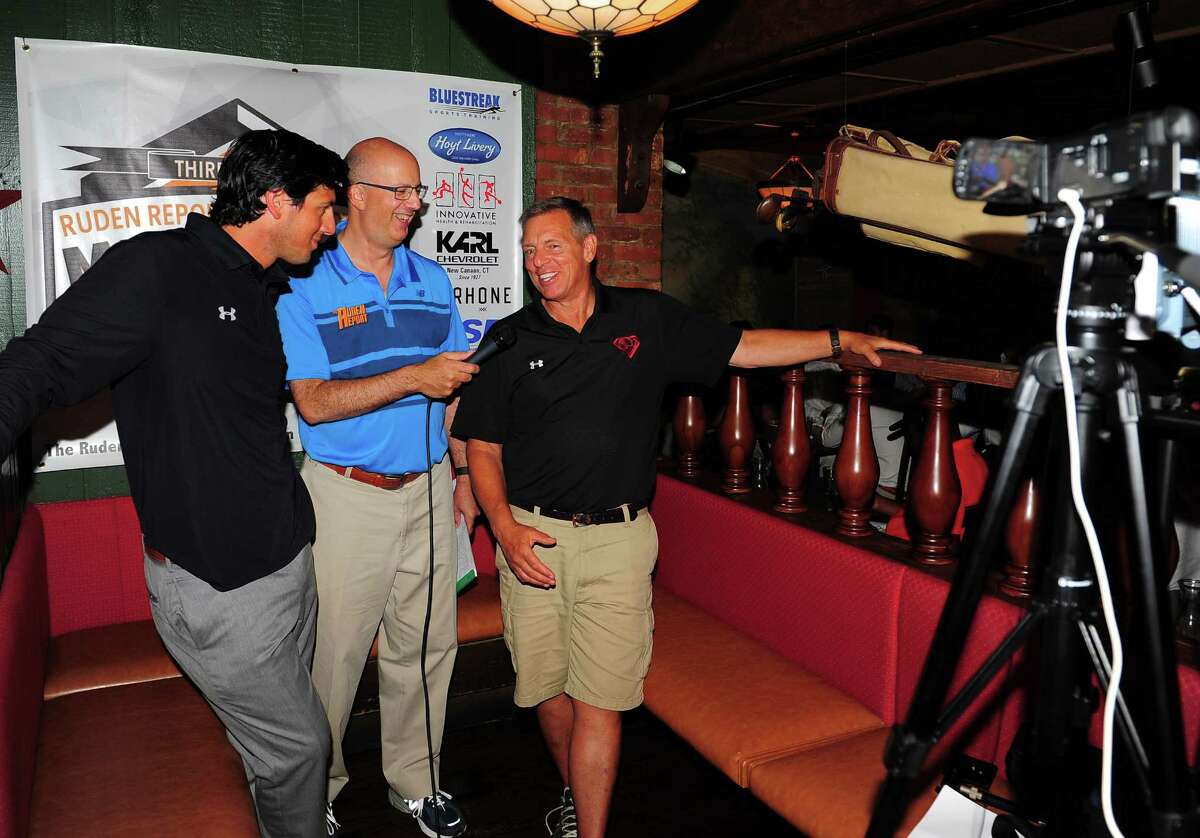 Dave Ruden, center, interviews father and son; New Canaan Head Coach Lou Marinelli and Greenwich Head Coach John Marinelli, left, during the 3rd Annual Ruden Report FCIAC Footbal Media Day held at Bogey's Grill & Tap Room in Norwalk, Conn. on Tuesday Sept. 8, 2015.