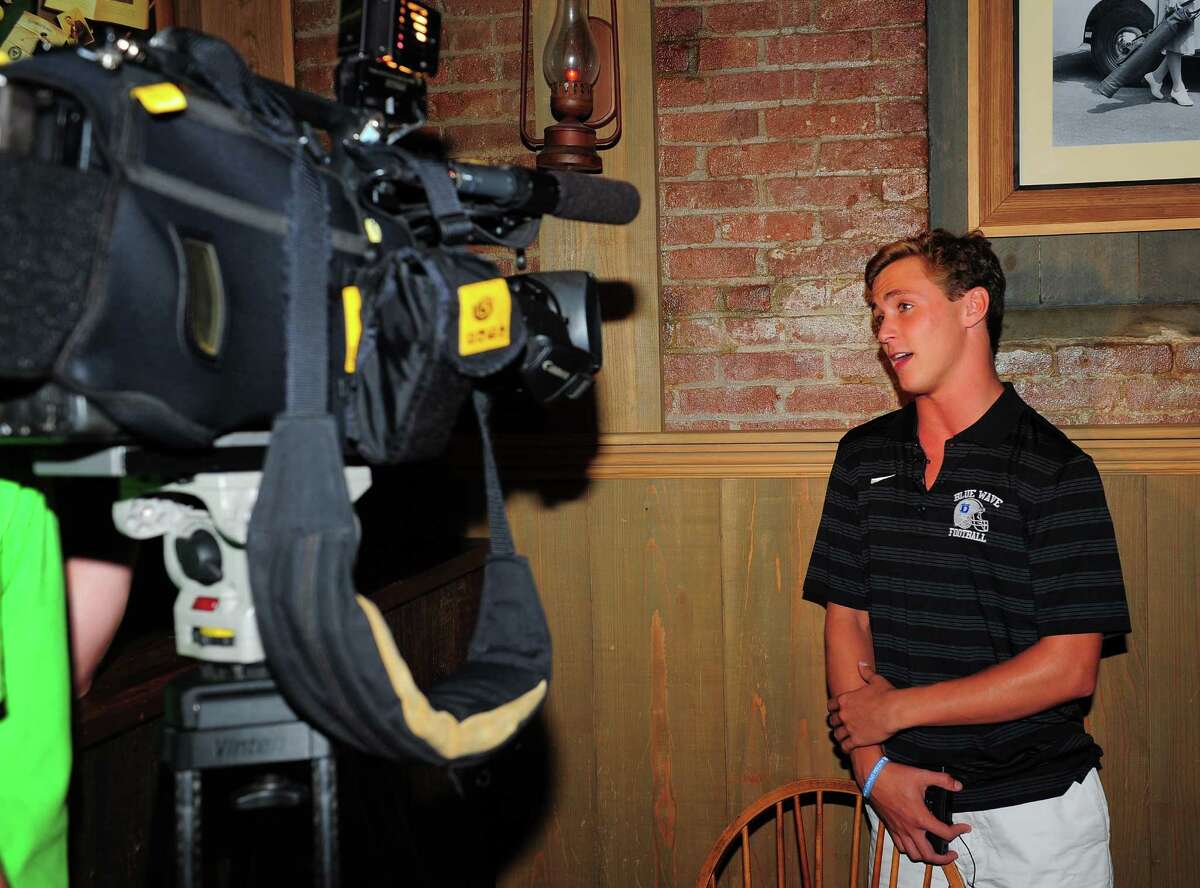 Darien player Bobby Trifone talks to Channel 12 during the 3rd Annual Ruden Report FCIAC Footbal Media Day held at Bogey's Grill & Tap Room in Norwalk, Conn. on Tuesday Sept. 8, 2015. Bobby's father Rob is the head coach and twin brother Christian is a teammate.