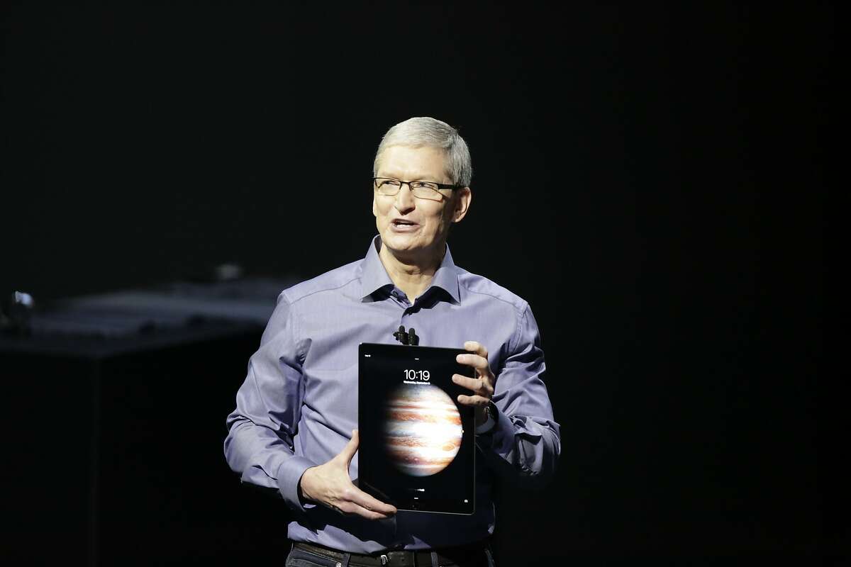 Tim Cook, chief executive officer of Apple Inc , holds the new iPad Pro during the Apple event at the Bill Graham Civic Auditorium on Wednesday, September 9, 2015 in San Francisco, Calif.