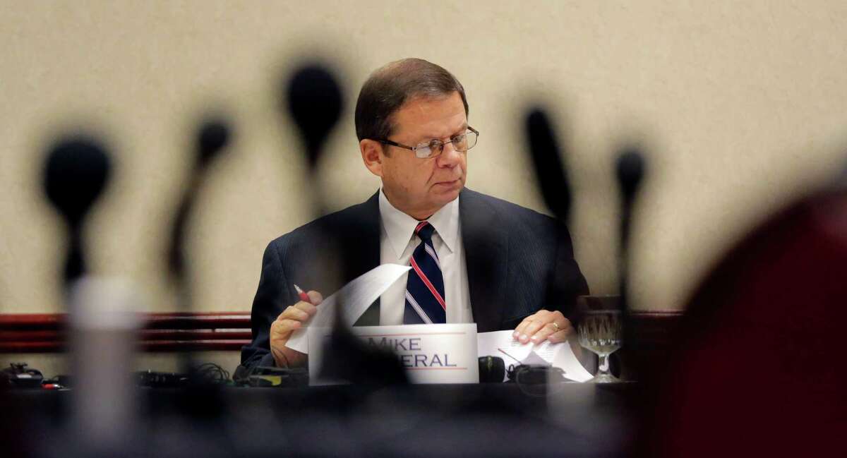 Mike Motheral, chairman of the University Interscholastic League (UIL) State Executive Committee, is seen through a cluster of microphones during an emergency meeting, Wednesday, Sept. 9, 2015, in Round Rock, Texas. The UIL, the governing body for high school sports in Texas, called the meeting to investigate two John Jay High School football players that hit a referee and the surrounding events.