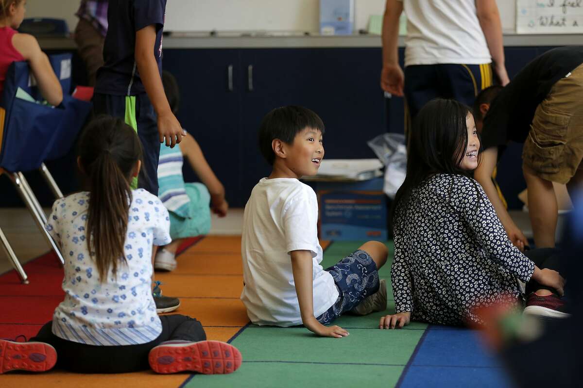 Darren Chao (center) and Jennifer Zhu (right) sit in a 4th grade classroom at the Chinese Immersion School at De Avila in San Francisco, California, on Wednesday, Sept. 9, 2015.