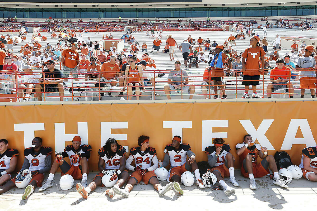 Texas players enjoy a water break during an open practice and fan appreciation day at Darrell K. Royal Memorial Stadium Sunday, Aug. 9, 2015.