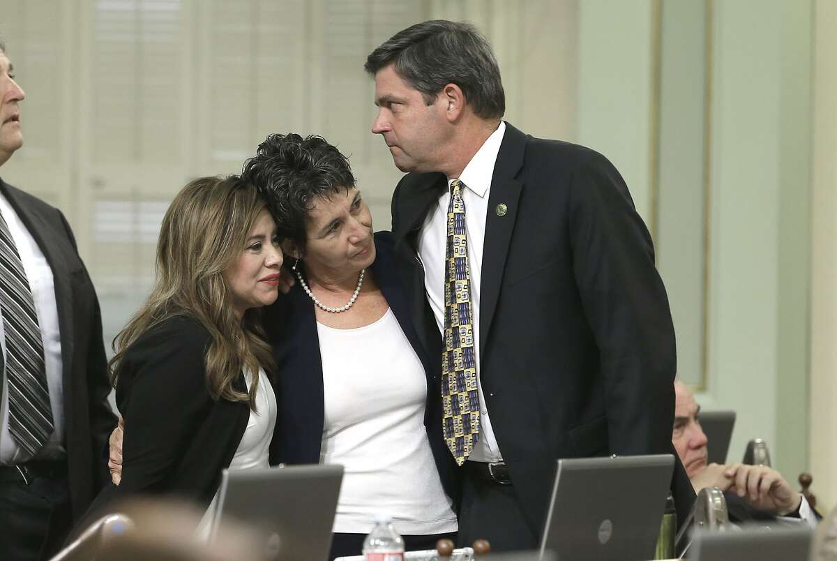 Assemblywoman Susan Talamantes Eggman, D-Stockton, center, is congratulated by Assembly members Nora Campos, D-San Jose and Jim Wood, D-Healdsburg, after her right-to die measure was approved by the state Assembly Wednesday, Sept. 9, 2015, in Sacramento, Calif. The bill, approved on a 42-33 vote, that would allow terminally ill patients to legally end their lives, now goes to the Senate.(AP Photo/Rich Pedroncelli)