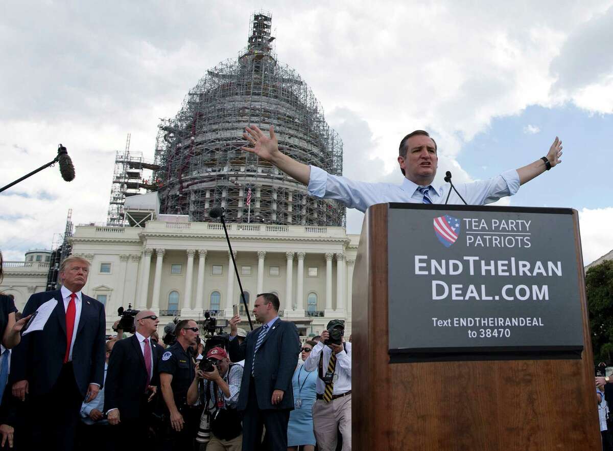 With Donald Trump listening at left, Sen. Ted Cruz, R-Texas, addresses the tea party rally on Capitol Hill.
