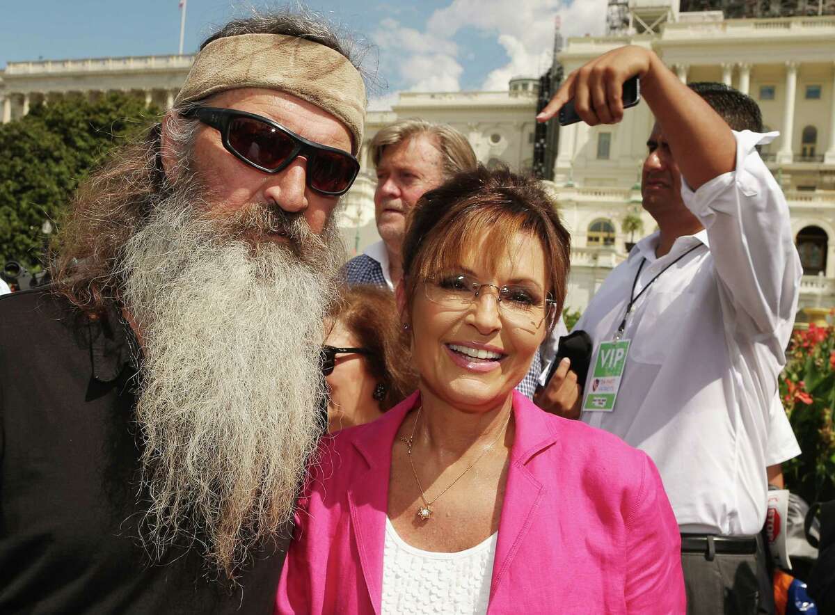 WASHINGTON, DC - SEPTEMBER 09: Reality television personality Phil Robertson (L) and Sarah Palin pose for photographs during a rally against the Iran nuclear deal on the West Lawn of the U.S. Capitol September 9, 2015 in Washington, D.C. Thousands of people gathered for the rally, organized by the Tea Party Patriots, which featured conservative pundits and politicians. (Photo by Chip Somodevilla/Getty Images)