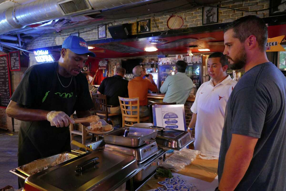 Edward Davis serves pulled Pork Sliders at Dick's Last Resort during day two of the three-day "The Taste" event on the River Walk on Wednesday, Sept. 9, 2015. The event is providing over 30 restaurants a showcase for their culinary prowess by serving appetizer-sized portions of signature dishes from their menus. Tuesday featured only restaurants located on Houston Street in downtown San Antonio. Day three on Thursday is also dedicated to River Walk restaurants.