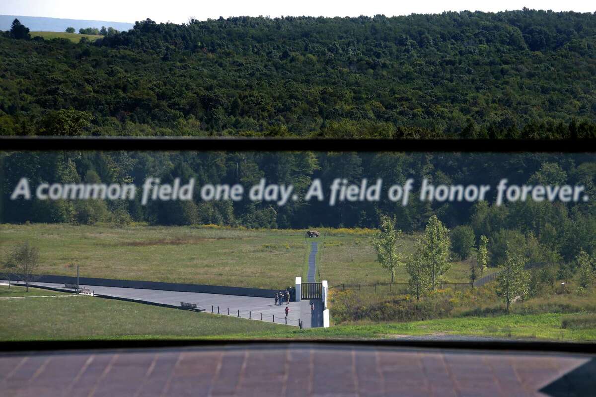 This is the view of the United Flight 93 crash site from the Flight 93 National Memorial's new Visitors center complex in Shanksville, Pa, on Wednesday, Sept. 9, 2015. The boulder, center rear, marks them plane's impact site. The visitors center will be formally dedicated and open to the public on Sept. 10, 2015. (AP Photo/Gene J. Puskar)
