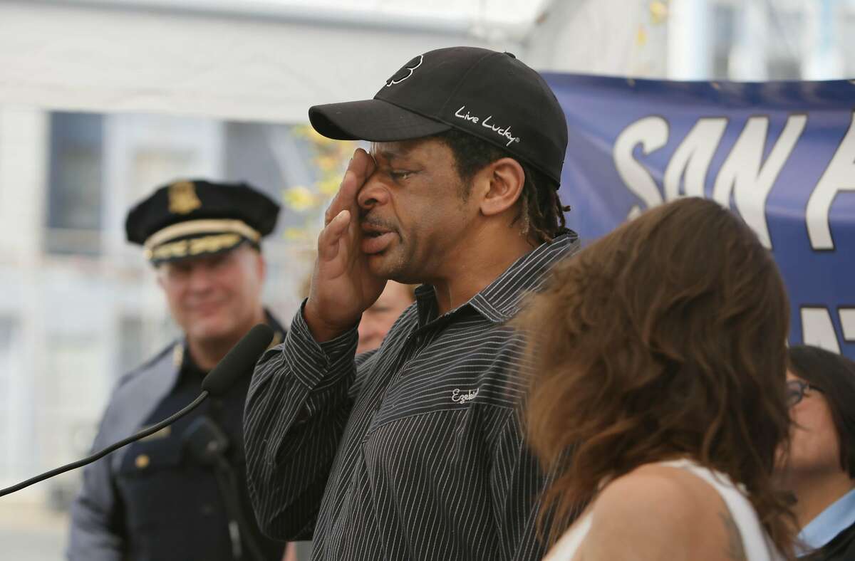 Victor Frazier (center) wipes a tear from his face while speaking about the difficulties of being homeless at a news conference in which Mayor Ed Lee spoke about the expansion of San Francisco's Navigation Center program on Thursday, September 10, 2015 in San Francisco, Calif.Frazier and Cynthia Balan (right) were homeless and are getting housing through the Navigation Center.