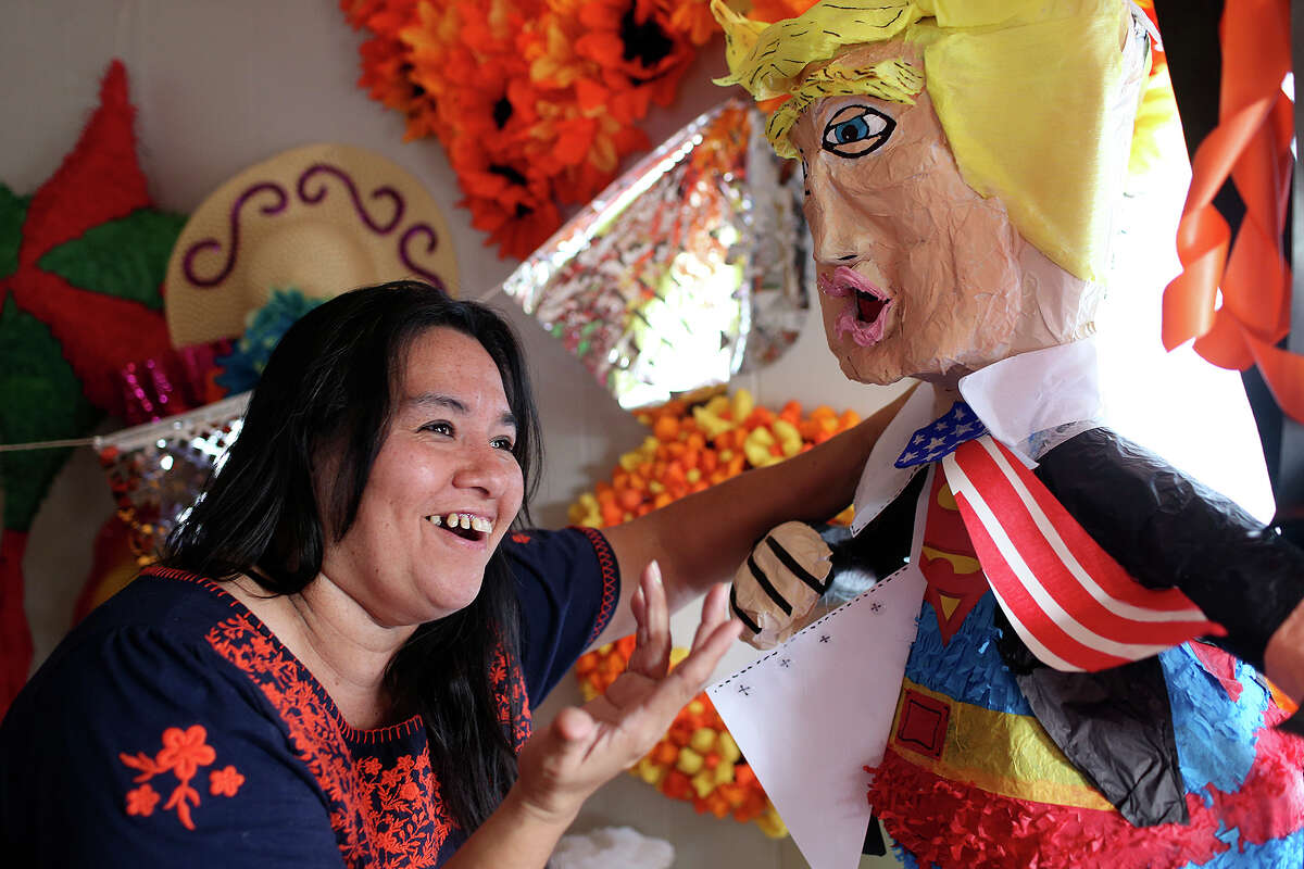 Marylou Hernandez shows off a Donald Trump piñata she's making for a client at her store, The Cascaron Store, on Austin Highway. A reader questions whether a story on Trump piñatas warranted front page coverage.