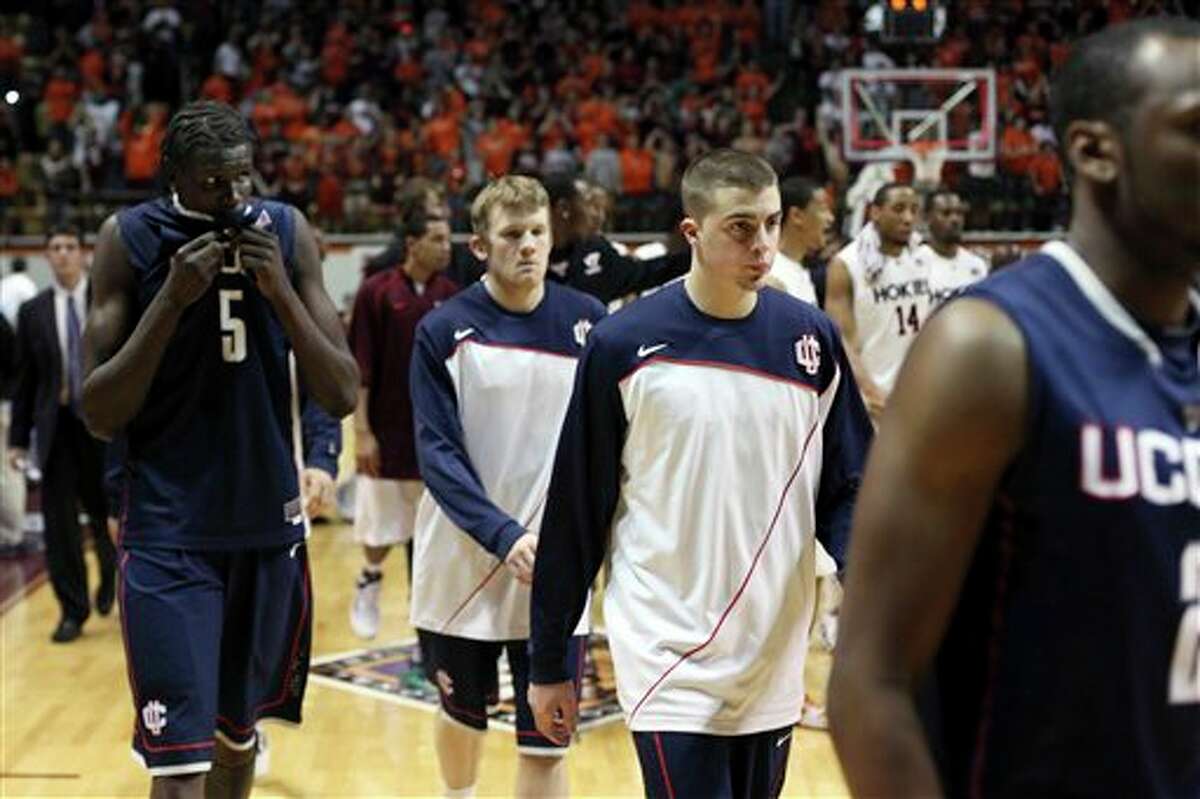 Connecticut's Ater Majak (5) and teammates walk off the court after Connecticut's 65-53 loss to Virginia Tech in a second-round NIT college basketball game in Blacksburg, Va., Monday,March 22, 2010. (AP Photo/The Roanoke Times, Matt Gentry)