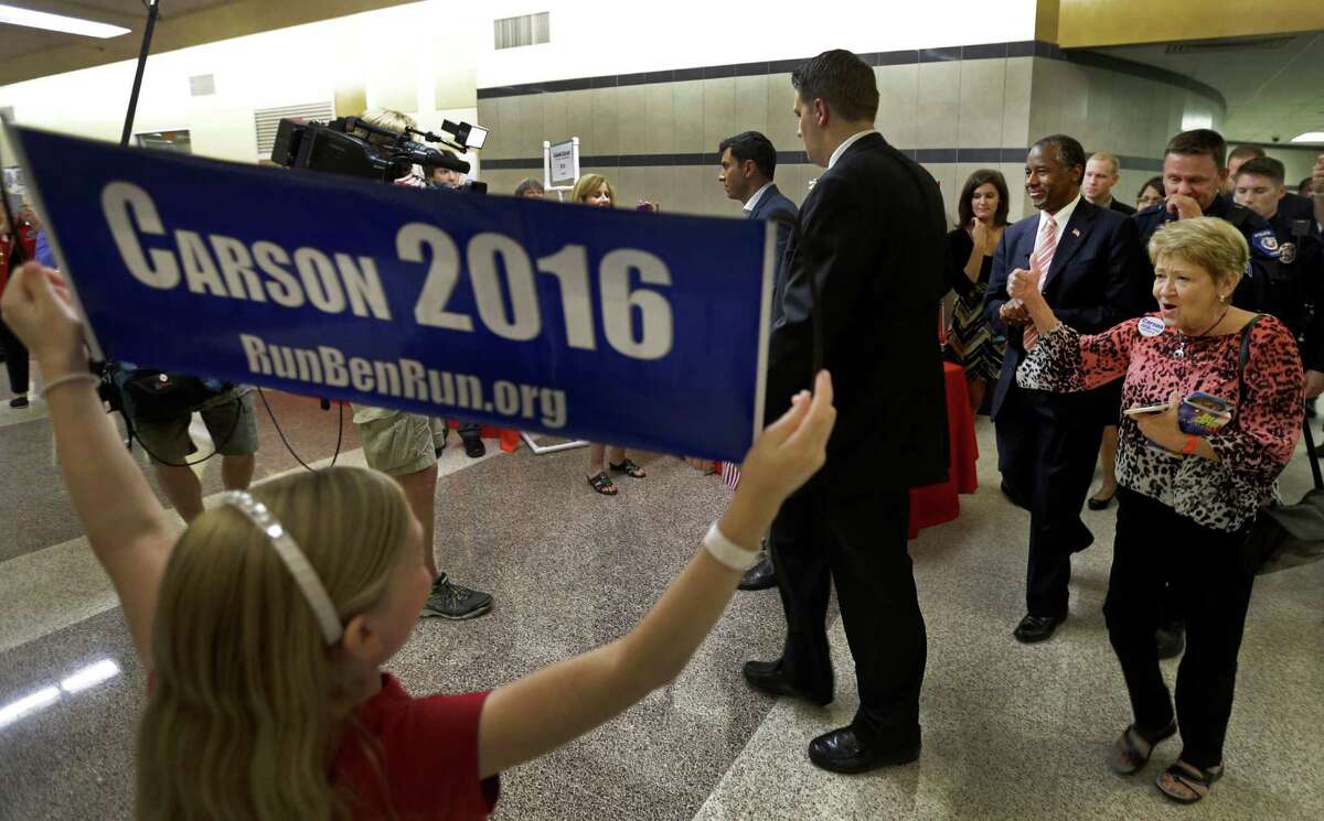 Republican presidential candidate Ben Carson is greeted by supporters Thursday for his speech at Conroe High School.