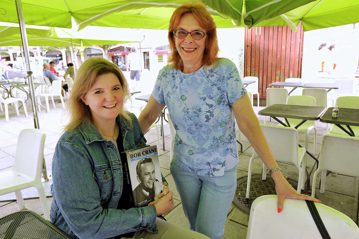 Carol Ford, left, and co-author Dee Young pose with their book "Bob Crane: The Definitive Biography" outside Capriccio Cafe in Stamford.