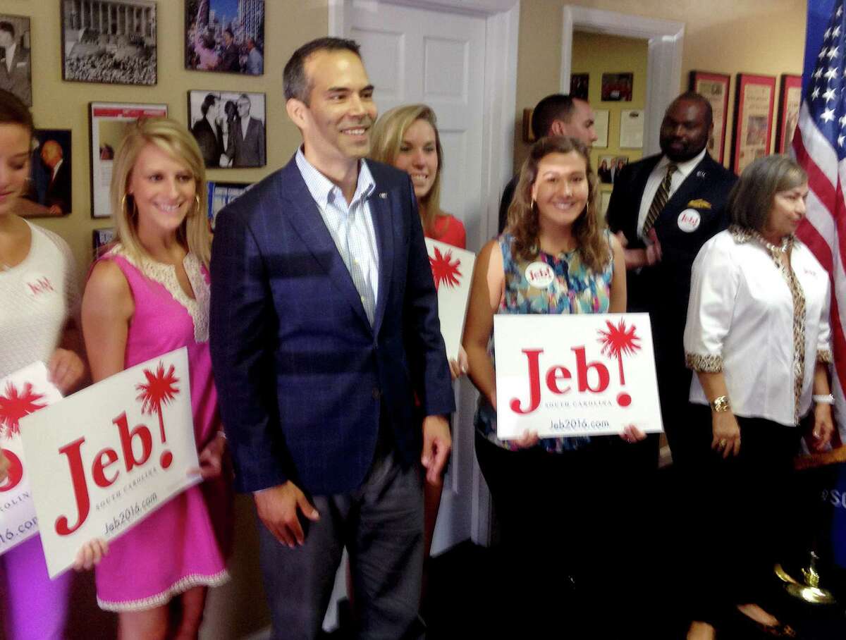 Texas Land Commissioner George P. Bush, third from the left, poses with supporters after turning in paperwork with the South Carolina Republican Party that will formally put his father Jeb's name on the state's 2016 presidential ballot on Friday, July 31, 2015, in Columbia, South Carolina. Bush has been helping members of his famous family get elected since age 3 but has never played a larger role as a political surrogate than this cycle, as he tries to help his dad follow his grandfather, George H.W. Bush, and his uncle, George W. Bush, to the White House. (AP Photo/Will Weissert)