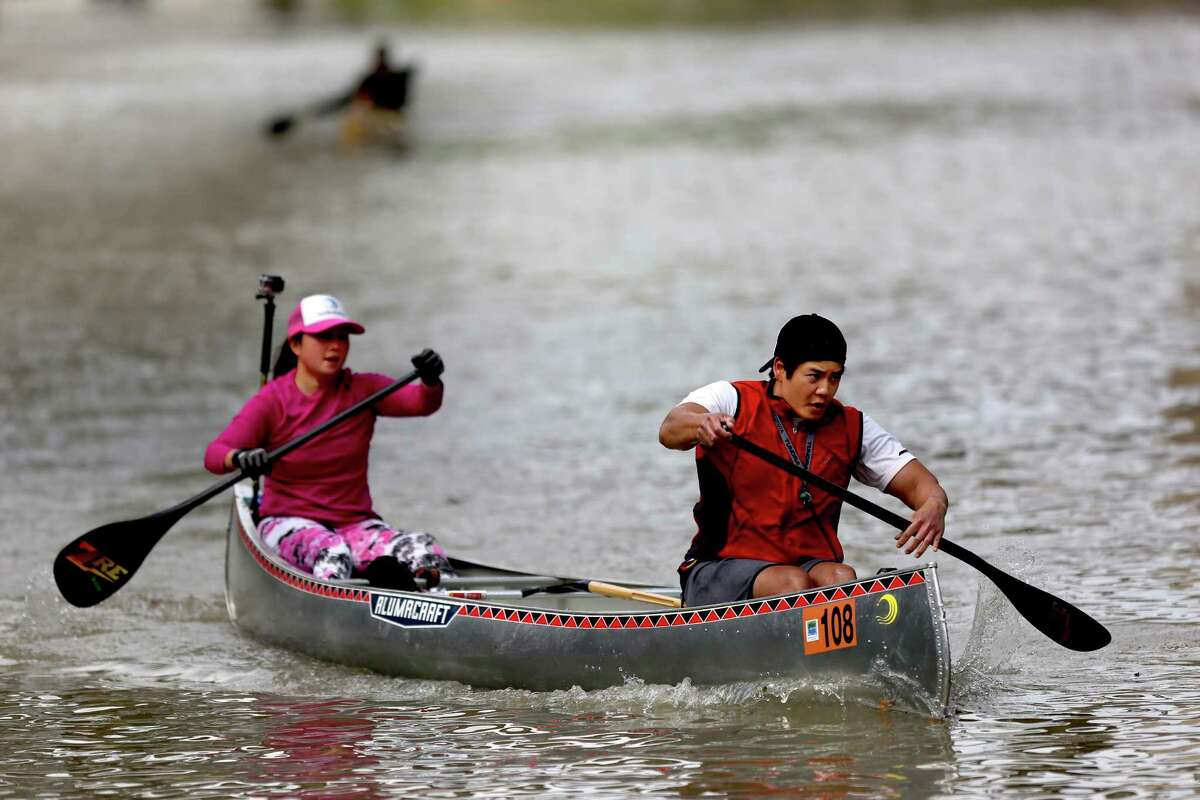 Paddlers Suzanne Pham and Hau Pham, of St. Arnold Brewing Company, in the Corporate Cup Coed category, in the 43rd Annual Buffalo Bayou Regatta, a 15-mile American Canoe Association (ACA) sanctioned race, along the scenic Buffalo Bayou Saturday, March 7, 2015, in Houston, Texas. Pham and Pham placed second with a time of 02:07:50.52. ( Gary Coronado / Houston Chronicle )