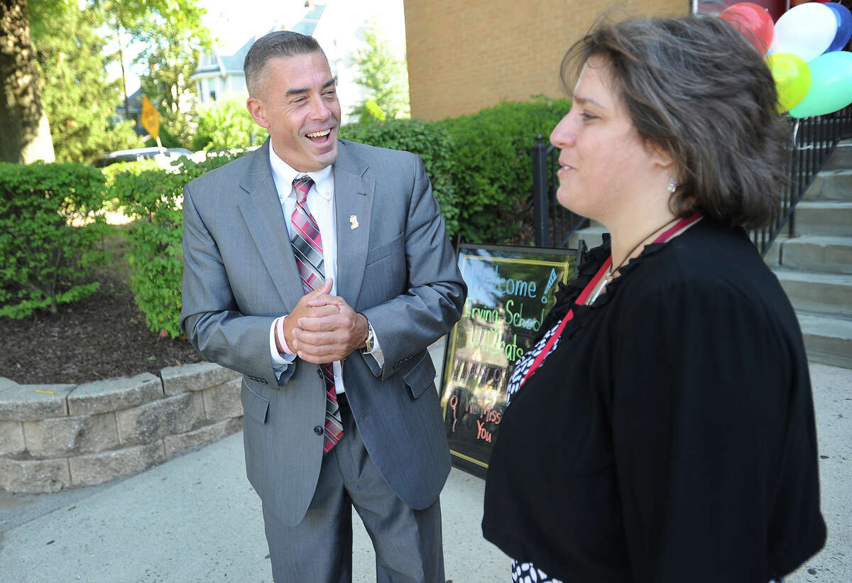 Derby school Superintendent Matthew Conway, left, chats with Principal Jennifer Olson as they welcome students on the first day of school outside Irving School in Derby, Conn. on Wednesday, August 26, 2015.