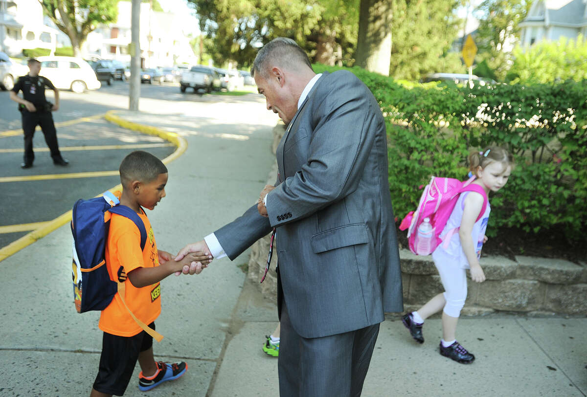 Derby school Superintendent Matthew Conway greets students as they arrive for the first day of classes at Irving School in Derby, Conn. on Wednesday, August 26, 2015.