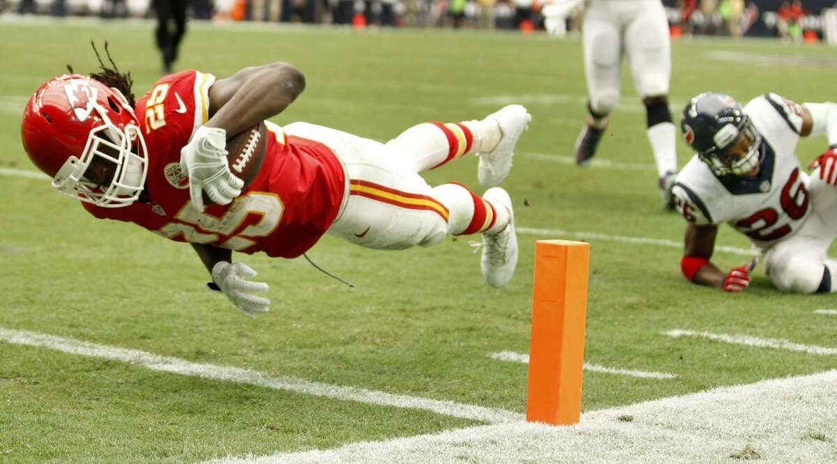 Kansas City Chiefs running back Jamaal Charles (25) dives into the end zone after breaking away from Houston Texans defensive back Rahim Moore (26) for a 7-yard touchdown reception during the second quarter of an NFL football game at NRG Stadium on Sunday, Sept. 13, 2015, in Houston. ( Brett Coomer / Houston Chronicle )