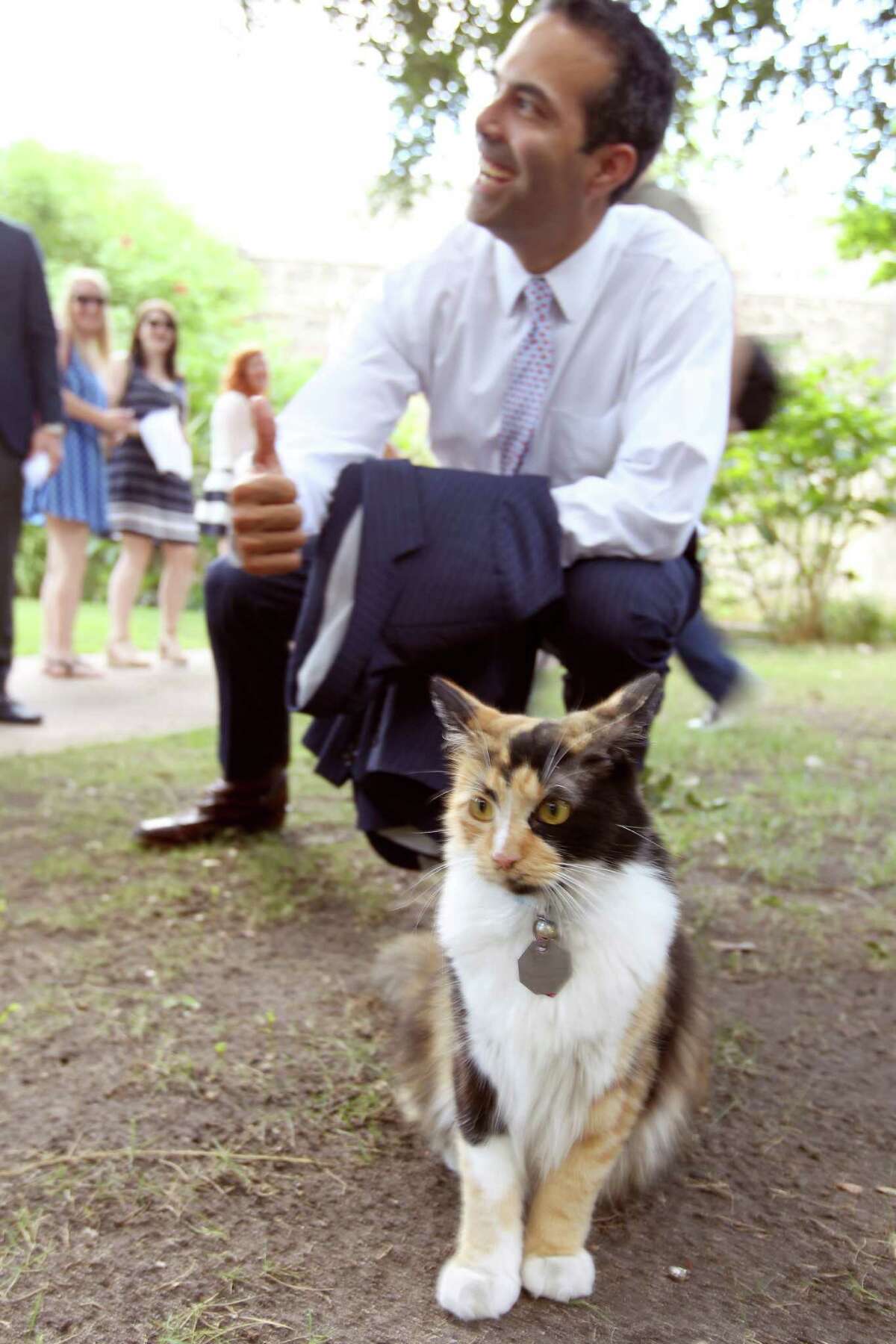 Texas Land Commissioner George P. Bush poses Wednesday Sept. 2, 2015 with Bella the Alamo Cat while on a tour of the Alamo grounds. Bush was in San Anotnio to celebrate the $31.5 million the General Land Office received to help preserve and develop the Alamo.