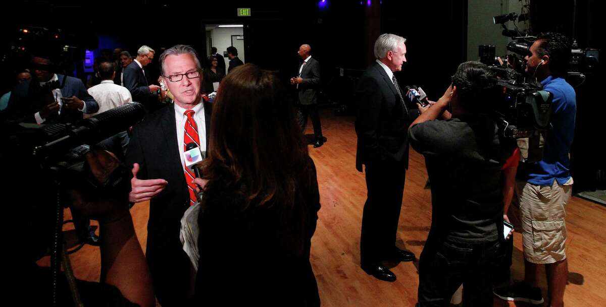 Steve Costello, left, and Bill King were among the mayoral candidates with microphones and cameras in their faces after last week's debate at the Hobby Center. Both candidates are courting conservative Houston voters as they bid to replace Annise Parker.