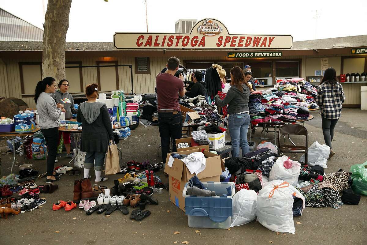Valley Fire evacuees look through donated clothes at the Napa County Fairgrounds in Calistoga, Calif., on Monday, September 14, 2015.