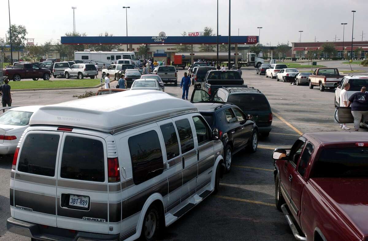 Drivers waited in line to fill up their cars with gasoline at a Beaumont Walmart on Sept. 26, 2005, just days after Hurricane Rita hit. Walmart had a portable generator that powered the pumps.