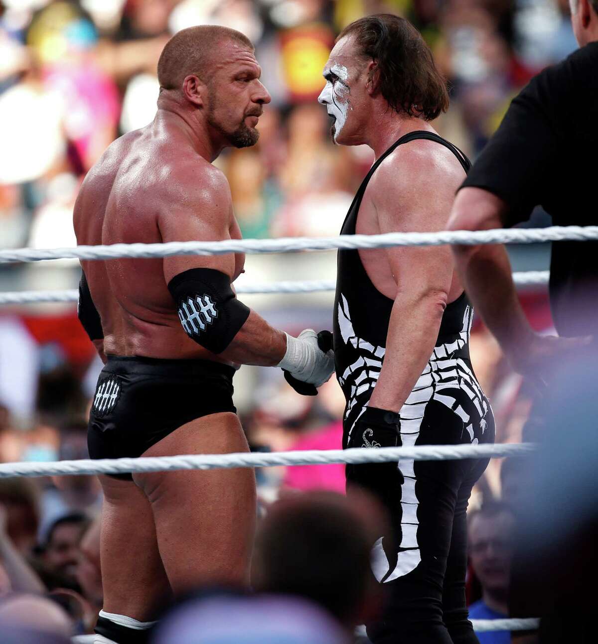 Triple H shakes hands with Sting after Triple H's win during WrestleMania at Levi's Stadium in Santa Clara, Calif., in March. Sting will make an appearance in Houston Sunday.