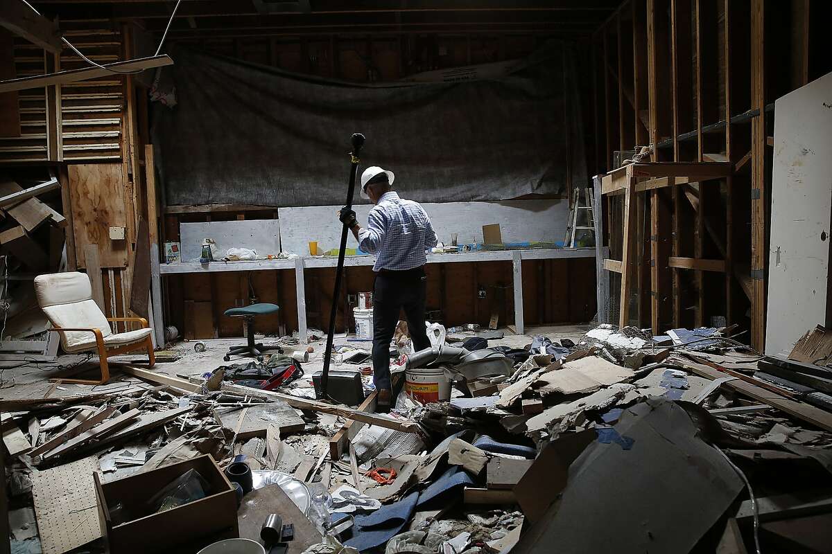 Walter Dawdiak walks through a vacant building that is often used by smash-and-grab thieves to sort their stuff. What they don't want, they just dump on the floor.
