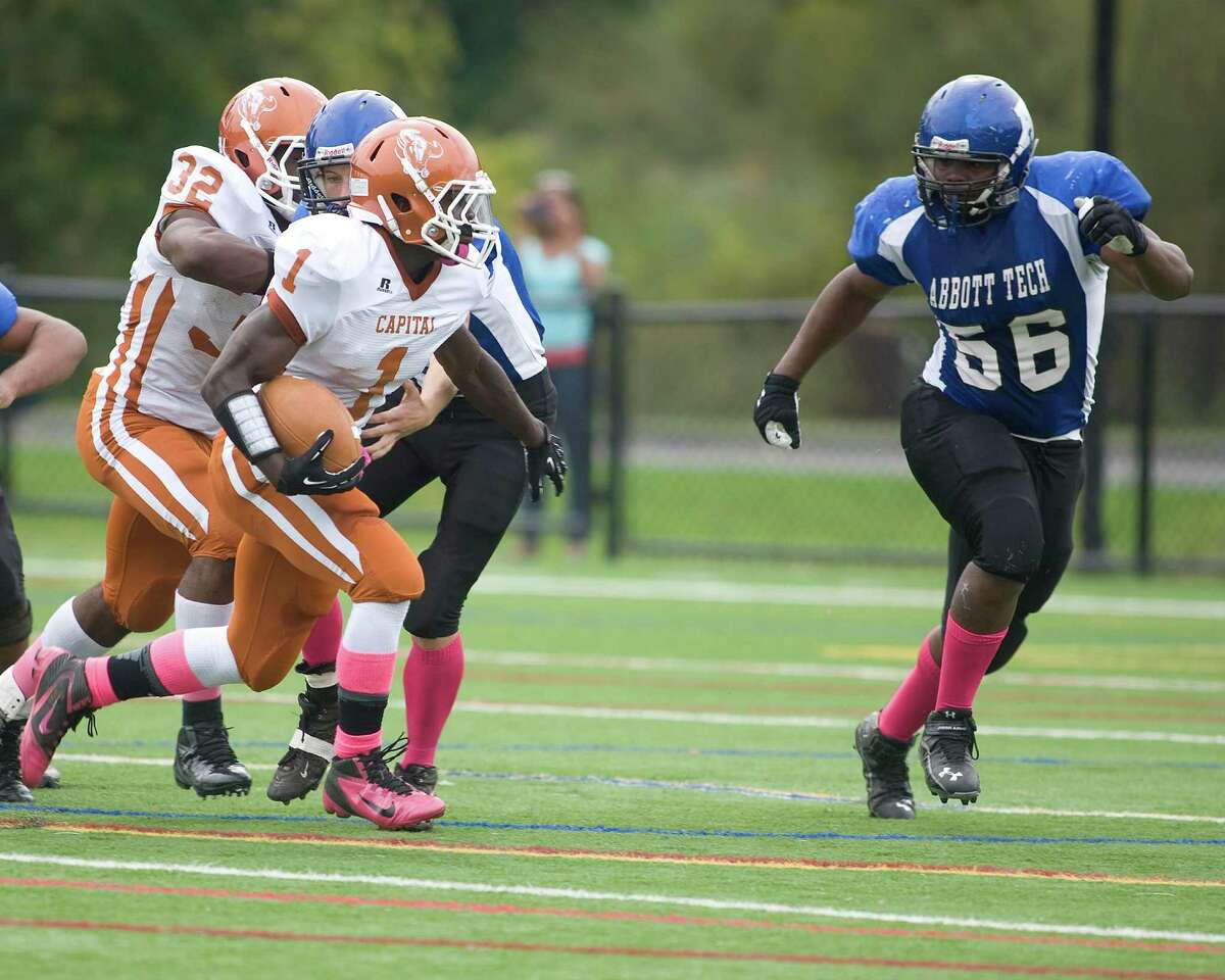 Abbott Tech's Delton Rogers moves in on Capital Prep running back Bennie Fulse during their football game Saturday, Oct. 6, 2012, at Rogers Park.