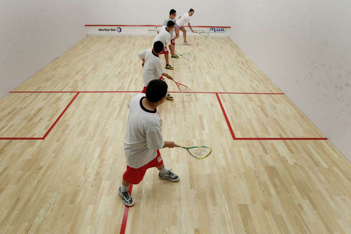 Hogg Middle School students start their first lesson in Squash by Squash Director Darya Musavi (left) Tuesday, Sept. 8, 2015, in Houston. The school recently constructed squash courts, which are the first squash courts at a public school in the country.